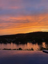 Scenic view of lake against romantic sky at sunset