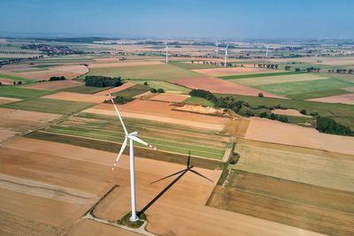 Windmill turbine in the field at summer day. rotating wind generator