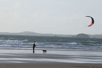 People on beach against sky