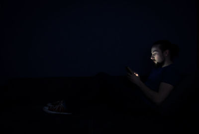 Man using mobile phone at night