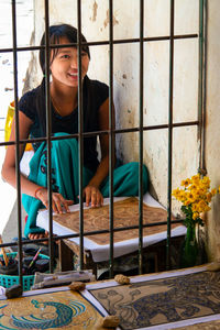 Portrait of woman sitting on chair at home