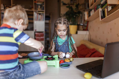 Cheerful kids with food on table