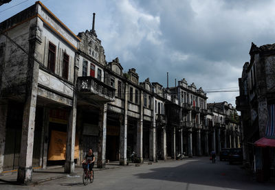 People walking on street amidst buildings in city