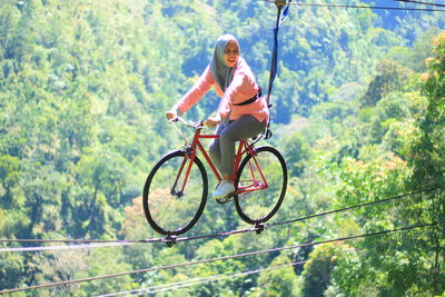 Low angle view of man riding bicycle on mountain