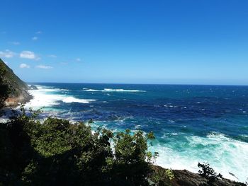 Scenic view of sea against blue sky