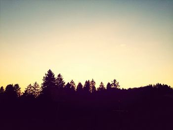 Silhouette of trees against sky at sunset