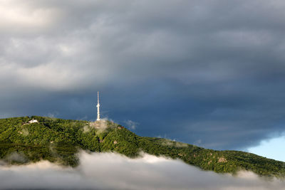 Panoramic view of the tv tower on top of the mountain against the sky