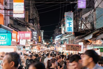 People on street in city at night