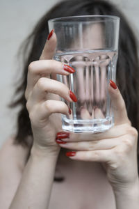 Cropped hand of woman holding drink