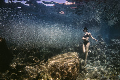 Full length of woman standing undersea