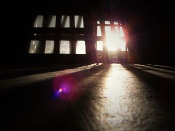 Sunlight streaming through window on silhouette of building