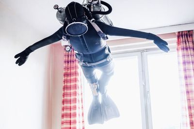 Low angle view of diving suit hanging at home