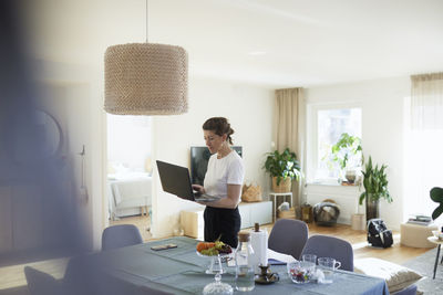 Woman using laptop at home