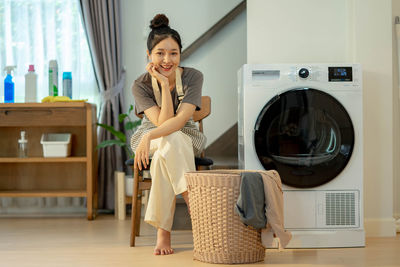 Portrait of young woman sitting at home