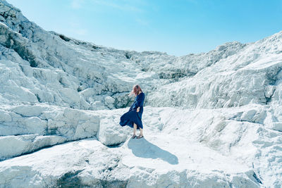 Full length of man standing on mountain against sky