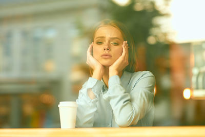 Portrait of young woman sitting at cafe