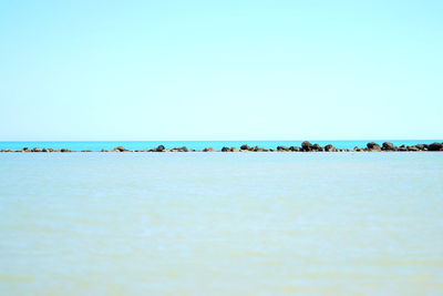 Scenic view of sea against clear blue sky