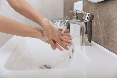 Faucet in sink in bathroom