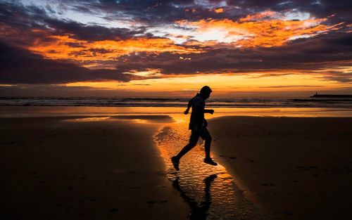 Scenic view of beach at sunset