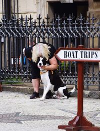 Woman with dog on street in city