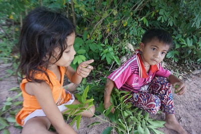 Mother and girl sitting outdoors