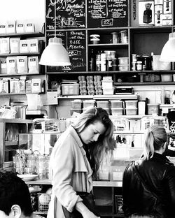 Young woman standing in front of store