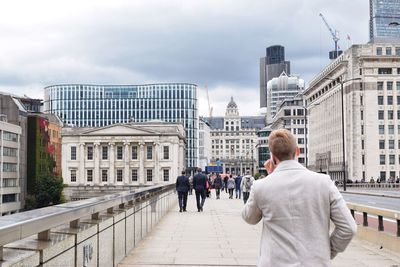 People in city against sky