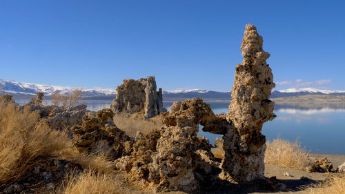 Panoramic view of rocks against blue sky