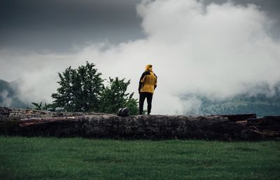 Man standing on field against sky