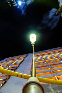 Low angle view of illuminated street light against sky at night