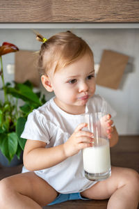 Portrait of cute baby boy sitting at home