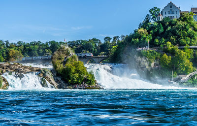 Scenic view of waterfall against sky