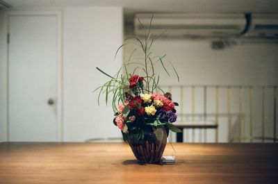 Close-up of roses in vase on table at home