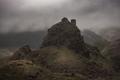 Scenic view of mountain against cloudy sky