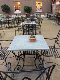 Chairs on sidewalk in city