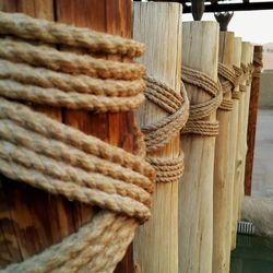 Close-up of rope tied to wooden post