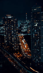 High angle view of city lit up at night