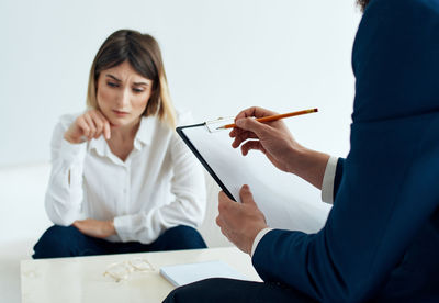 Midsection of doctor examining patient at clinic