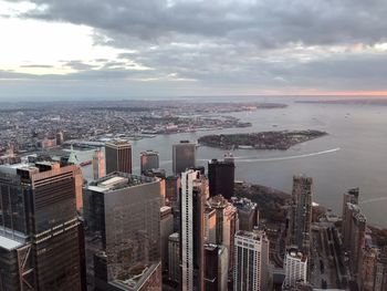 Aerial view at sunset of the downtown manhattan, governors island and the new york harbor.