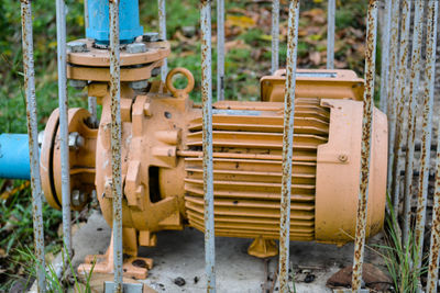 Close-up of old machine part on field