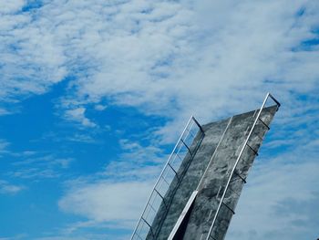 Low angle view of bascule bridge against cloudy sky