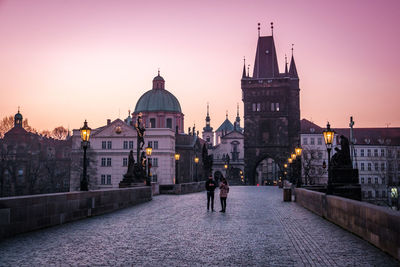 Buildings in city at sunset