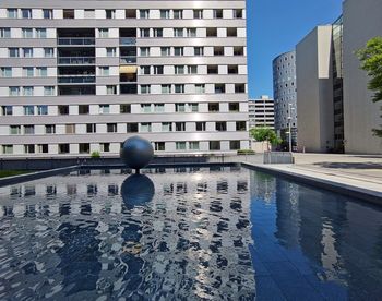 Swimming pool against buildings in city