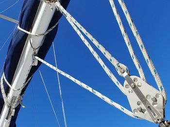 Low angle view of cables against clear blue sky