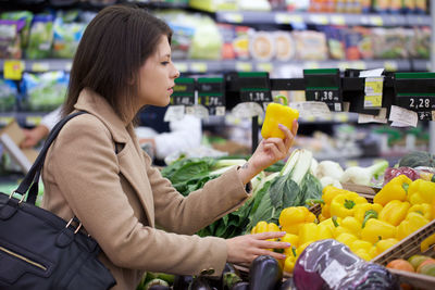 Woman buying food at supermarket