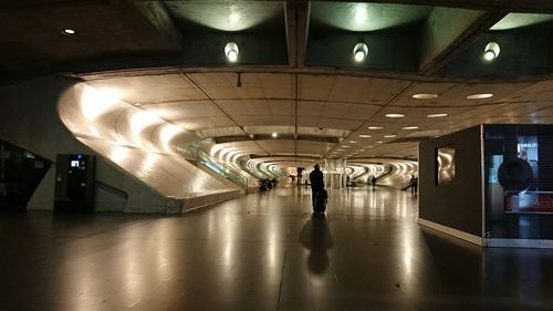 Rear view of people walking in subway station