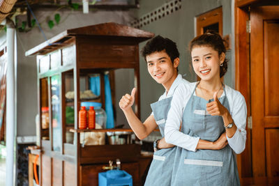 Portrait of young businesswoman standing in store