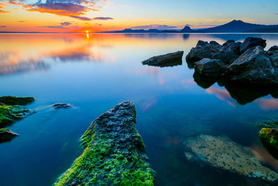 Scenic view of sea against sky at sunset