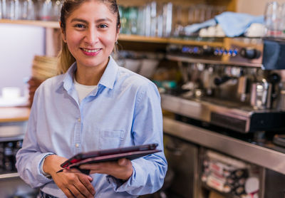 Portrait of barista standing at cafe