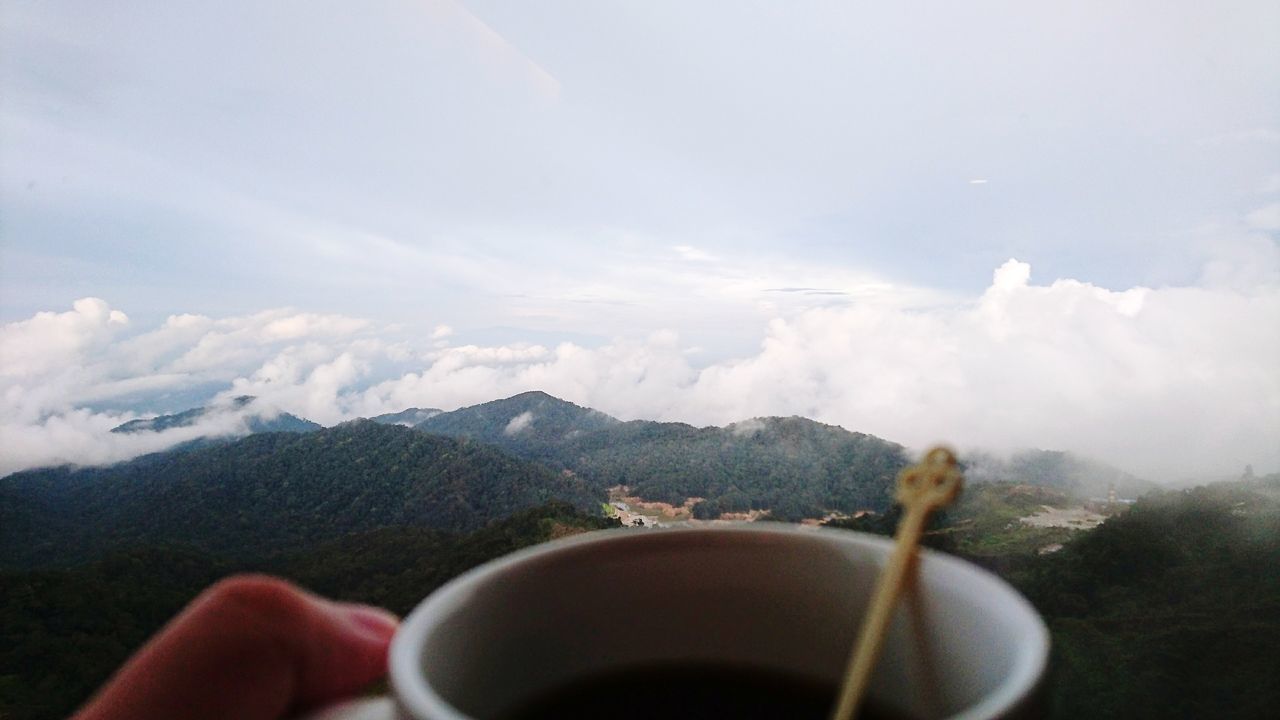 coffee - drink, drink, coffee cup, food and drink, refreshment, mountain, one person, human hand, human body part, real people, freshness, holding, close-up, sky, mountain range, nature, landscape, tea - hot drink, day, indoors, people